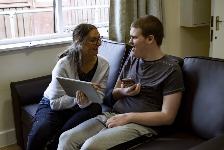 A young man with little verbal ability being empowered through alternative communication techniques.